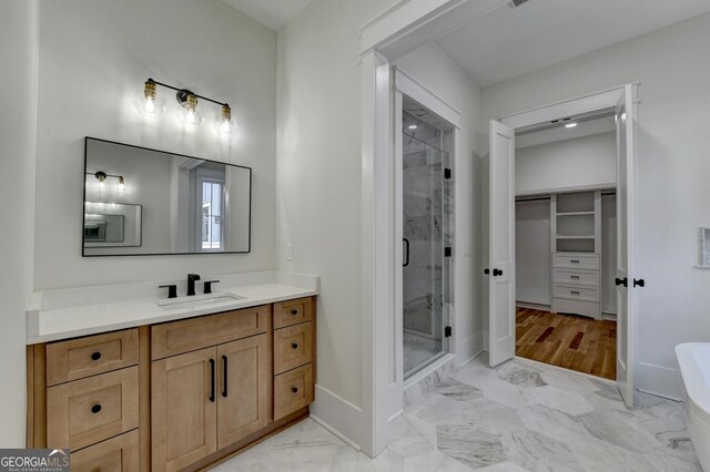 bathroom featuring walk in shower and vanity