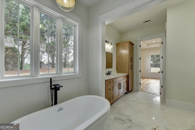 bathroom featuring vanity and a tub