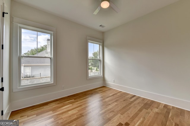 empty room featuring ceiling fan and light wood-type flooring