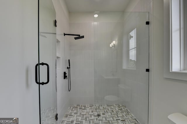 bathroom with an enclosed shower and toilet