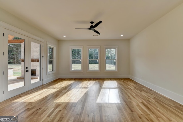 interior space with light hardwood / wood-style floors, french doors, and ceiling fan