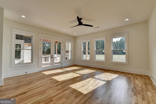 interior space with a wealth of natural light, french doors, and light wood-type flooring