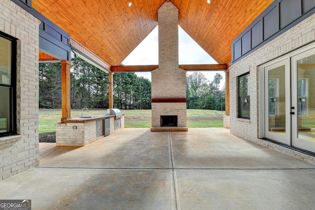 view of patio / terrace with an outdoor brick fireplace, area for grilling, grilling area, and sink