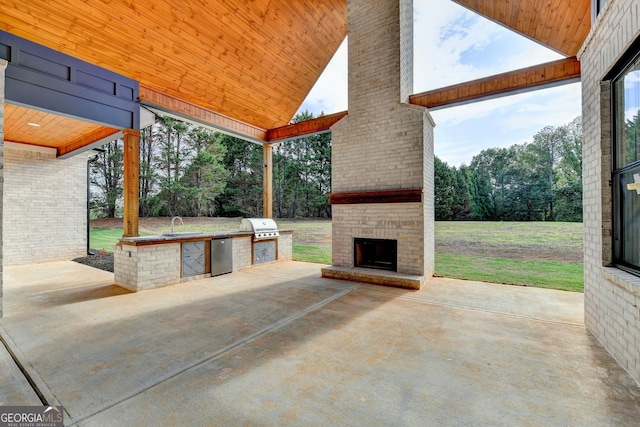 view of patio / terrace featuring an outdoor brick fireplace, a grill, area for grilling, and sink