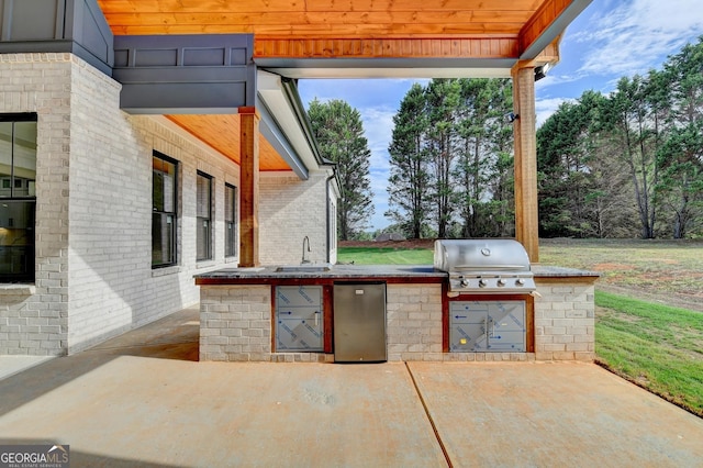 view of patio / terrace with area for grilling, sink, and a grill