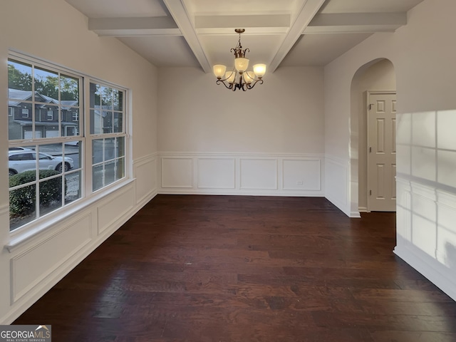 unfurnished dining area with beamed ceiling, dark hardwood / wood-style floors, and an inviting chandelier