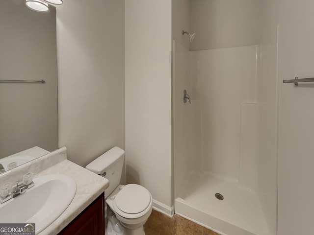 bathroom with a shower, vanity, and toilet