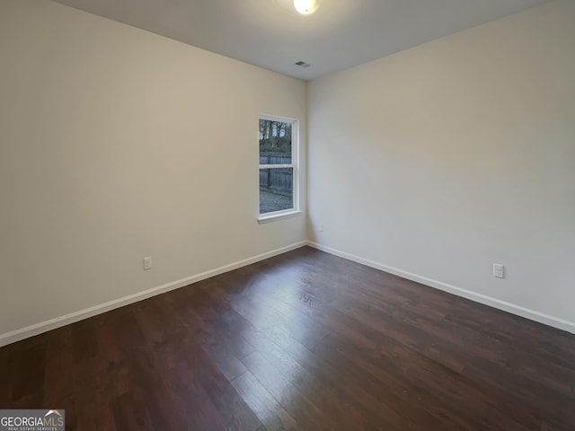 empty room featuring dark wood-type flooring