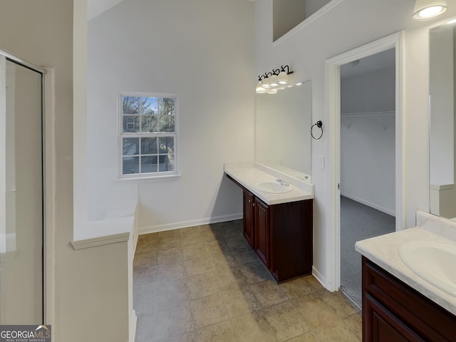 bathroom with vanity and a shower with shower door