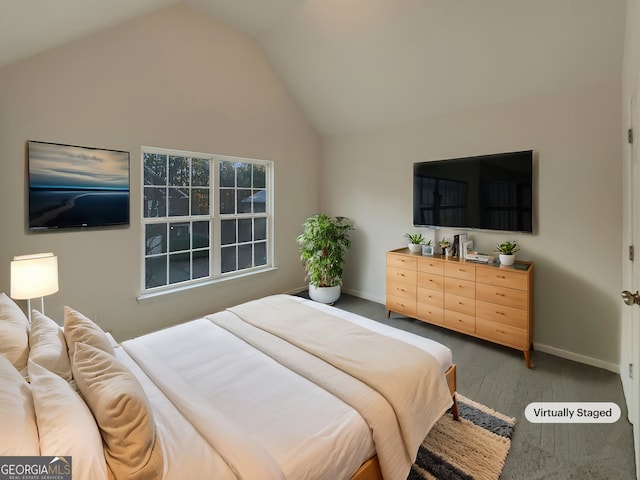 bedroom featuring lofted ceiling and hardwood / wood-style floors