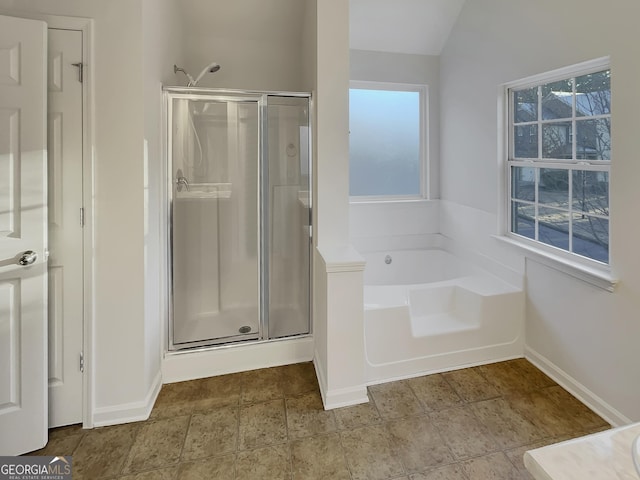 bathroom with separate shower and tub and lofted ceiling