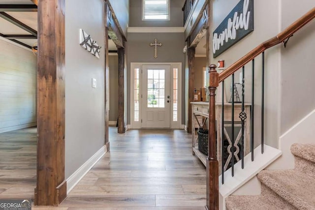 foyer with wood-type flooring and a high ceiling