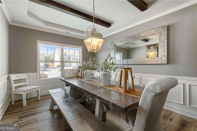 dining space featuring beamed ceiling, ornamental molding, and dark wood-type flooring