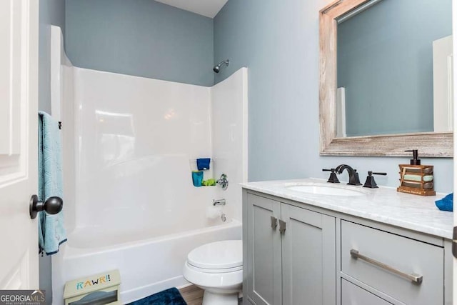 full bathroom featuring vanity, tub / shower combination, and toilet