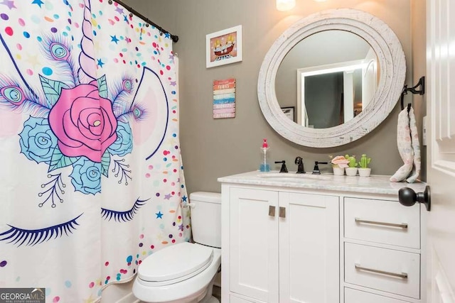 bathroom featuring vanity and toilet