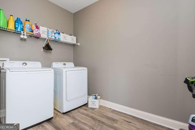 washroom featuring hardwood / wood-style flooring and washer and clothes dryer