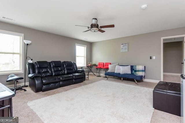 carpeted living room featuring ceiling fan