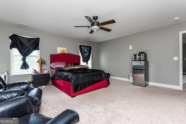 bedroom with stainless steel refrigerator, ceiling fan, and carpet