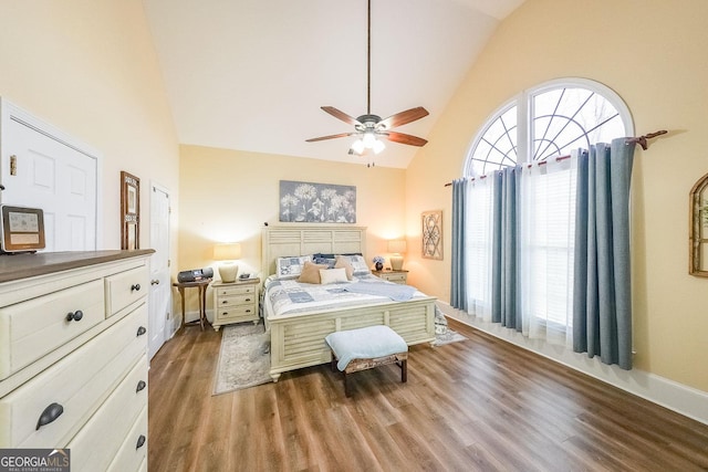 bedroom featuring hardwood / wood-style flooring, high vaulted ceiling, and ceiling fan