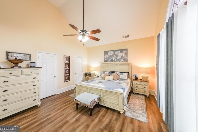 bedroom featuring ceiling fan, wood-type flooring, and high vaulted ceiling