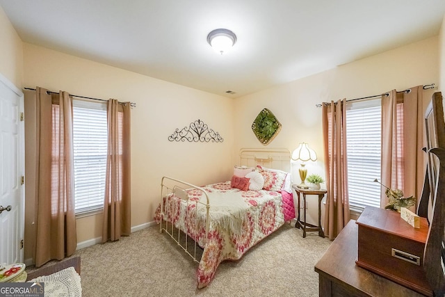 bedroom featuring light carpet