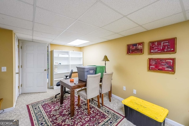 interior space featuring carpet floors and a paneled ceiling