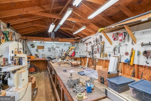 miscellaneous room with lofted ceiling and a workshop area