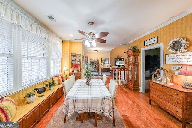 dining room featuring crown molding, ceiling fan, and light wood-type flooring