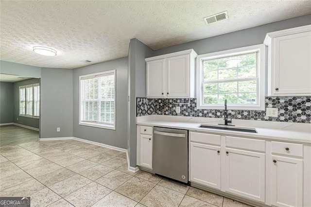 kitchen featuring sink, white cabinetry, a textured ceiling, dishwasher, and backsplash