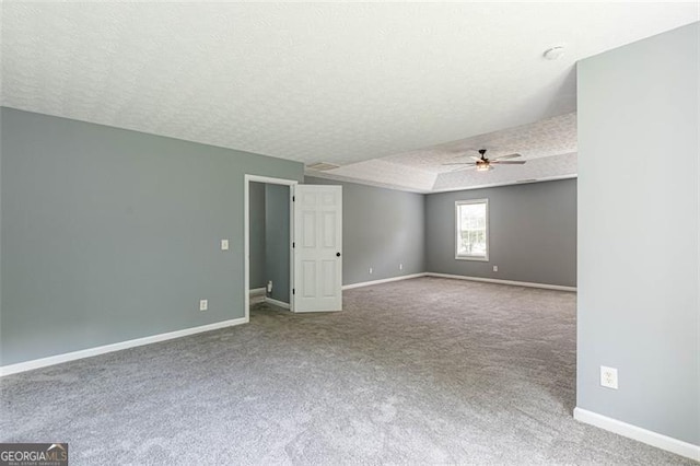 carpeted spare room with ceiling fan and a textured ceiling