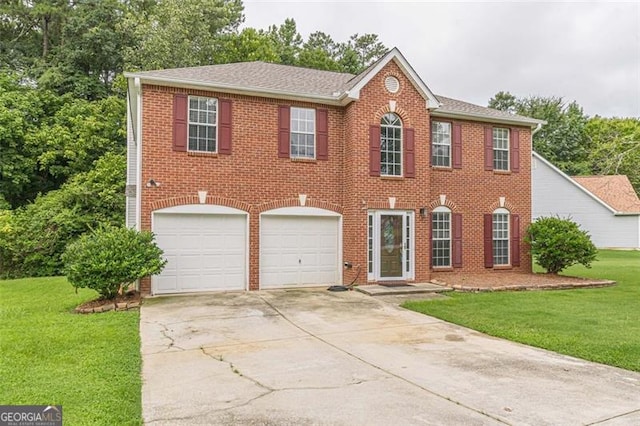 colonial home with a garage and a front lawn