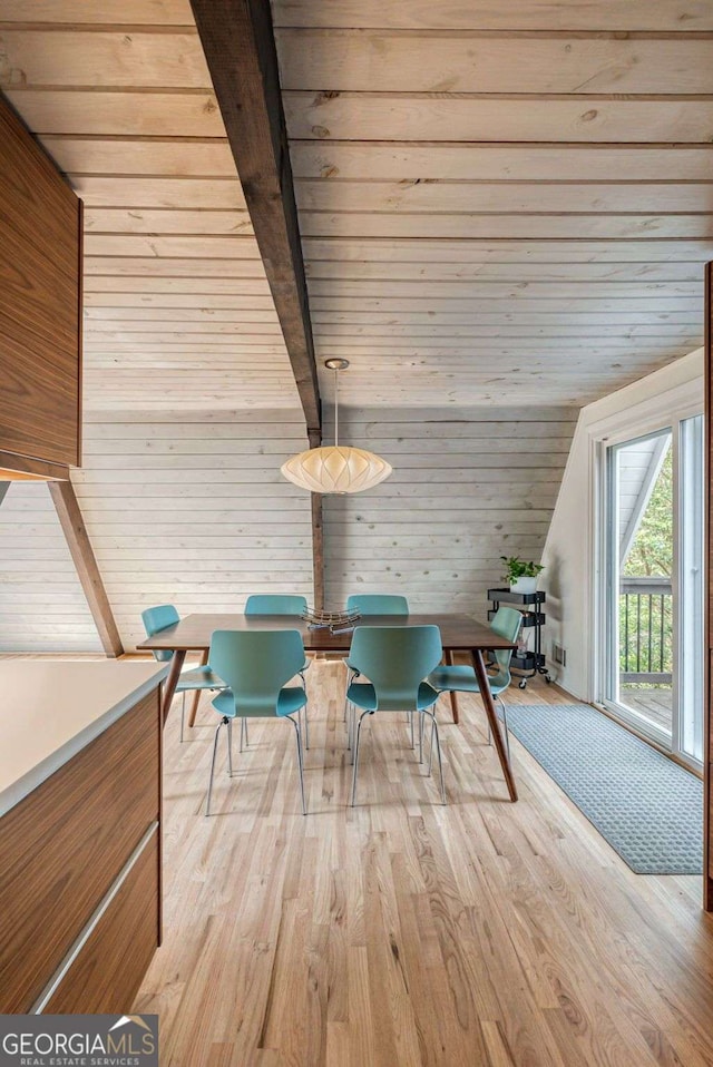 unfurnished room featuring vaulted ceiling with beams, wooden ceiling, wood walls, and light wood-type flooring