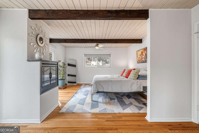 bedroom with hardwood / wood-style flooring, ceiling fan, wooden ceiling, and beam ceiling