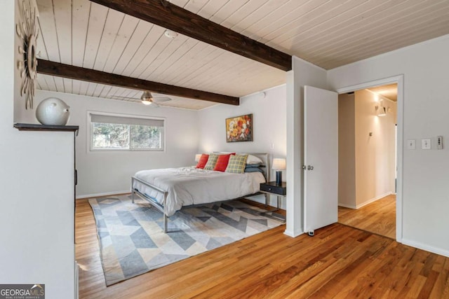 bedroom featuring wood ceiling, beam ceiling, wood-type flooring, and ceiling fan