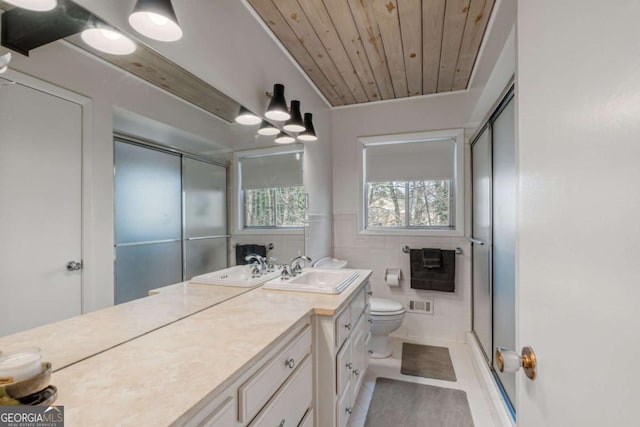 bathroom with tile patterned flooring, tile walls, vanity, wooden ceiling, and toilet