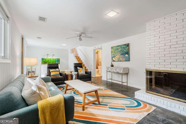 living room with ceiling fan and a brick fireplace