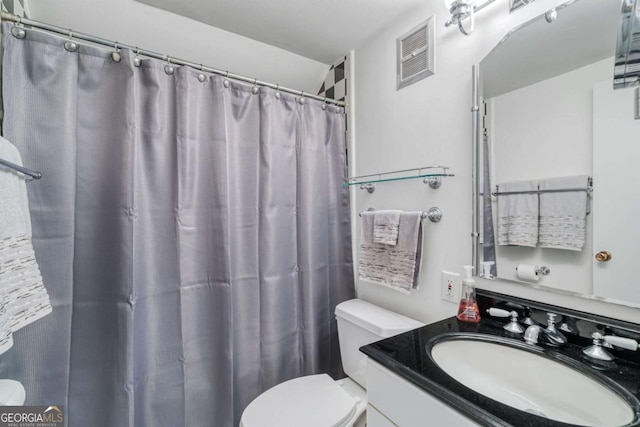 bathroom with vanity, a shower with curtain, and toilet