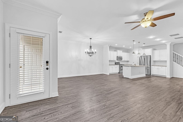 unfurnished living room featuring ornamental molding, sink, dark hardwood / wood-style floors, and ceiling fan with notable chandelier