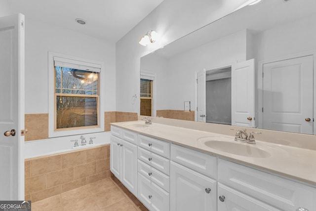 bathroom with vanity, tiled tub, and tile patterned floors