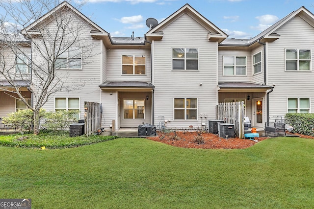 rear view of house featuring a patio area and a lawn