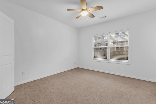 carpeted empty room featuring ceiling fan