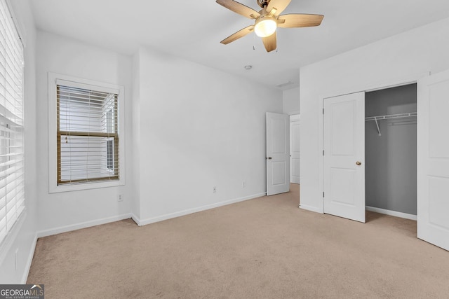 unfurnished bedroom with multiple windows and light colored carpet