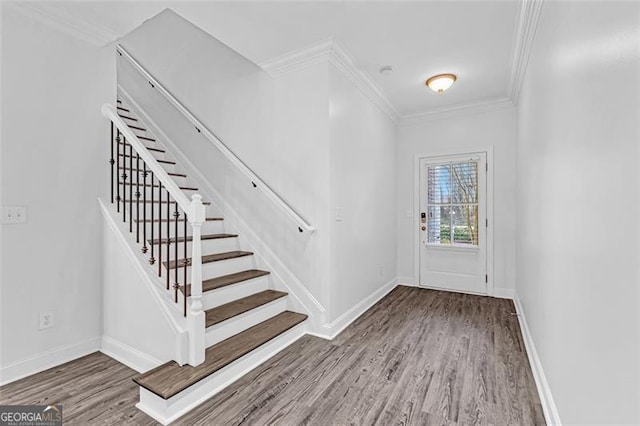 entryway featuring crown molding and hardwood / wood-style flooring