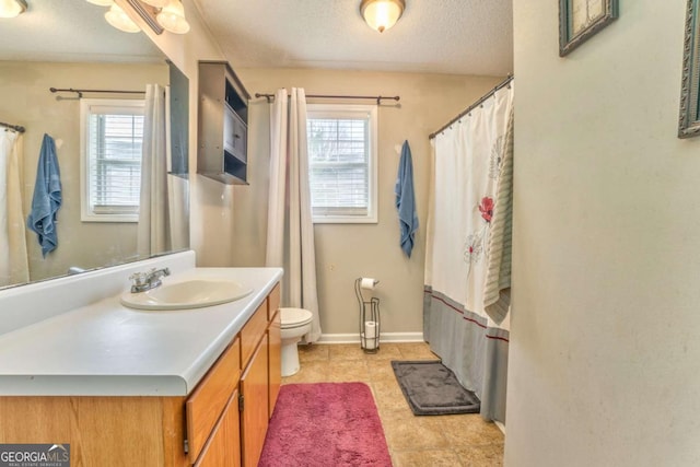 full bathroom with vanity, a wealth of natural light, a textured ceiling, and toilet