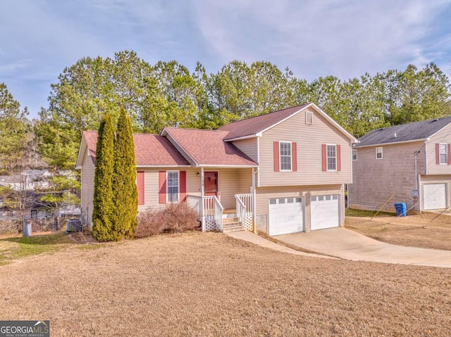 split level home with cooling unit and a garage