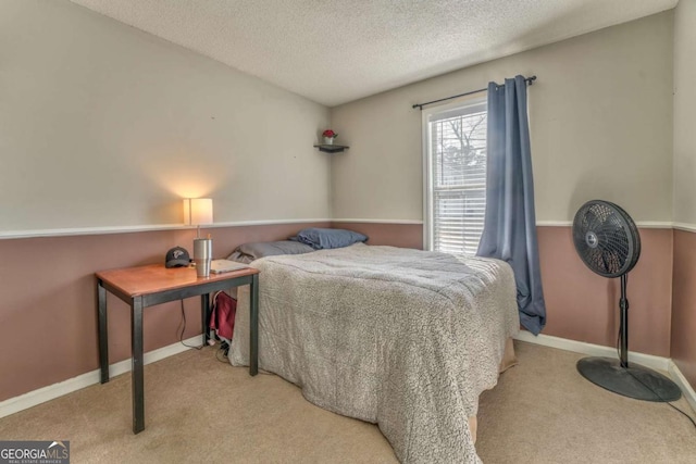 bedroom with light colored carpet and a textured ceiling