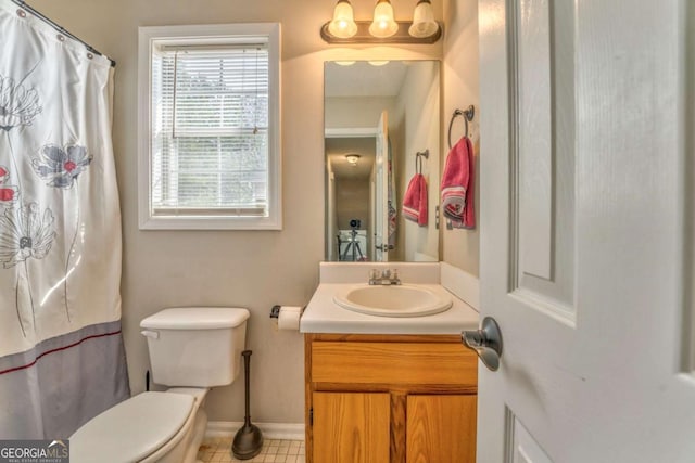 bathroom featuring vanity and toilet