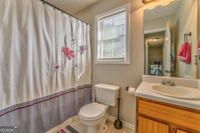 bathroom featuring vanity, tile patterned flooring, and toilet