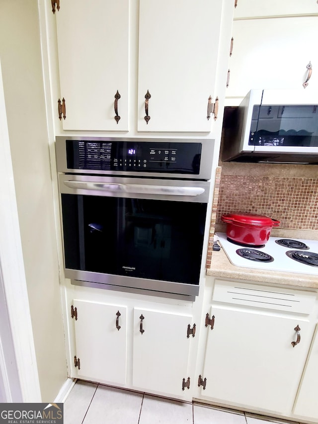 kitchen with white cabinetry, appliances with stainless steel finishes, and decorative backsplash