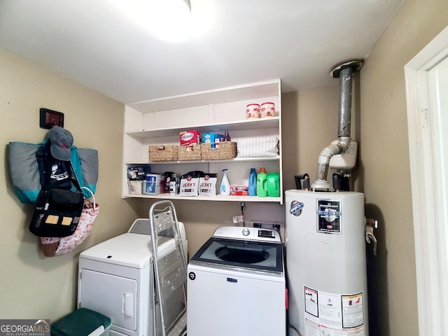 washroom with water heater and independent washer and dryer